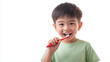 © Thanakorn - Happy Asian boy brushing teeth with red toothbrush in green t shirt