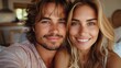 © Алина Бузунова - Happy young caucasian couple taking a selfie with keys to their new apartment, smiling and looking at the camera in a modern kitchen interior at home