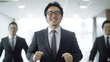 © pattozher - Confident Leader: A determined businessman with a confident smile, leading his team towards success in a modern office environment. This powerful image embodies ambition, drive.