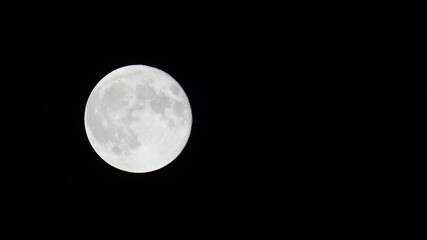 Wall Mural - Stunning 4K video of a full moon filmed at night with telephoto lens.
