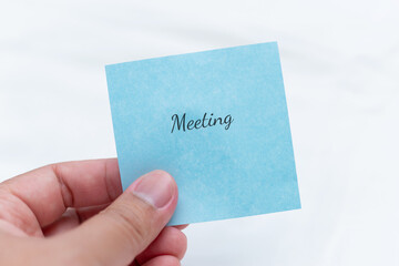 Poster - Professional office workspace with handwritten meeting reminder note close-up organizational concept