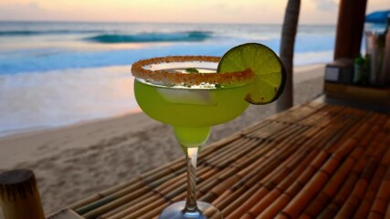 Wall Mural - An elegant and creative presentation of a Margarita cocktail at a beach bar, garnished with fresh lime and a salted rim, capturing the refreshing spirit of a tropical getaway.