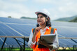 © Deemerwha studio - Female engineer in uniform with solar panel is working check and notepad quality in solar farm. solar green energy technology. Clean alternative or renewable power sources concept