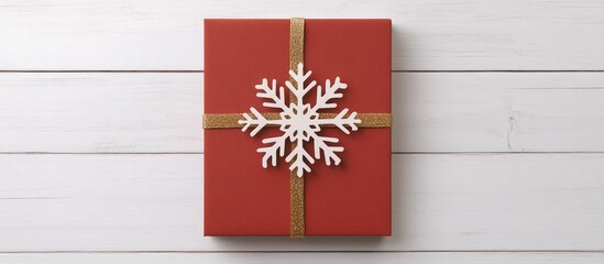 Wall Mural - Christmas gift box with snowflake decoration on wooden floor festive holiday greeting background