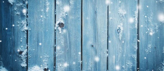 Poster - Blue wooden texture with snowflakes creating a serene winter background for rustic or seasonal design themes