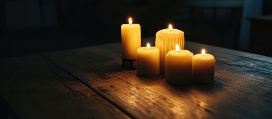 Poster - Advent candles glowing softly on rustic wooden table creating a warm and inviting atmosphere for the holiday season