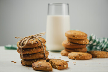 Wall Mural - Oatmeal cookies with a glass of milk on a light table. Delicious and healthy breakfast