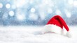 © Nikolai - A bright red Santa hat rests peacefully on a blanket of pristine snow, symbolizing the joy and warmth of Christmas festivities.