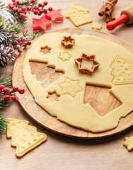 Wall Mural - Christmas baking: preparing dough for festive cookies with various cookie cutters