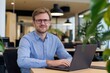 © photo of people - Young male professional IT specialist business working on laptop pc sitting at desk in modern office. 30s man using computer technology app for work.