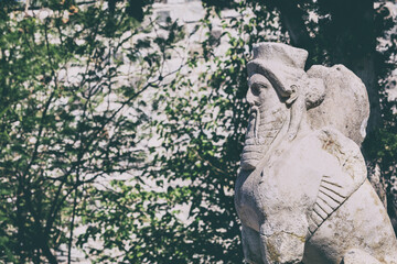 Wall Mural - Stone sphinx sculpture at Bodrum Castle, surrounded by greenery and historic architecture, showcasing ancient craftsmanship and mythology. Bodrum, Mugla, Turkey (Turkiye)