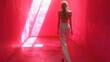 © Somchai - Crimson Runway: A woman in white pantsuit strides confidently down a vibrant pink corridor, bathed in dramatic light.  The image evokes a sense of mystery, power, and modern fashion.