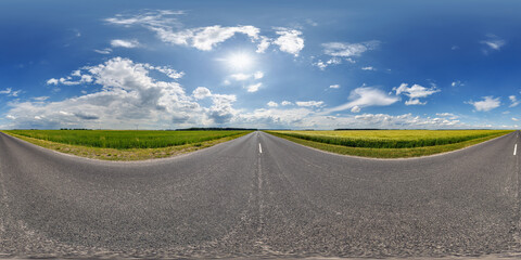 Wall Mural - spherical 360 hdri panorama on old asphalt road with clouds and sun on blue sky in equirectangular s