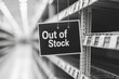 © ItziesDesign - Empty shelves in a store with an 'Out of Stock' sign indicating shortages.