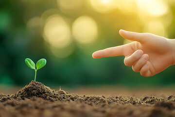 Wall Mural - A Hand Points to a Tiny Sprout Emerging from the Soil, Symbolizing New Growth, Environmental Conservation, and a Brighter Future