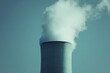 © Olga - Cooling tower emitting steam against clear blue sky