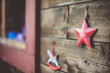 © RooM The Agency - Close-up of a rocking horse and star shaped Christmas ornaments hanging on a wooden stall at a Christmas market, Innsbruck, Tyrol, Austria