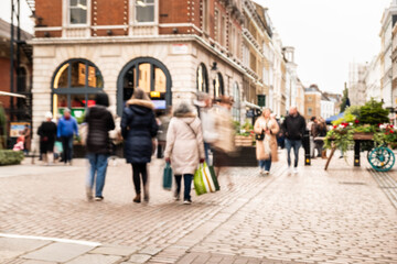 Wall Mural - Busy shopping street scene with motion blur