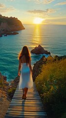 Wall Mural - Serene Sunset Stroll: A woman in a flowing white dress walks along a wooden boardwalk towards a breathtaking sunset over the ocean. The image evokes tranquility and wanderlust.