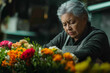 © Юля Бурмистрова - Senior woman arranging colorful flowers in a peaceful floral shop setting. Generative AI