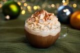 Cup of coffee with whipped cream and marshmallows on holiday christmas background.