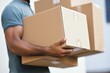 © Vadym - Man carrying cardboard boxes during apartment relocation. Closeup view of strong arms carrying boxes. Home relocation, new home, moving, life event. Homeownership, belonging feeling. Indoor space,