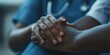 © Pech - Close-up of doctorâ€™s hand on a patientâ€™s, emphasizing connection and empathy in medical care.