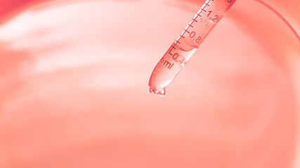 Wall Mural - close-up orange science experiment background,macro science experiment pipette surface,