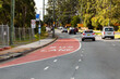 © Austockphoto - Bus Lane marking on road with sign and traffic passing