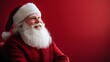 © rehan - Santa Claus Smiles Against Red Background