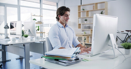 Poster - Man, computer and typing in office for business, administration and financial planning. Male accountant, tech and documents in agency for feedback, company banking and payment management for audit