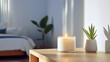 © ibooM - A burning scented candle in an uncluttered bedroom