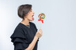 © lara-sh - Portrait of beautiful woman with sweets round lollipop in her hand.