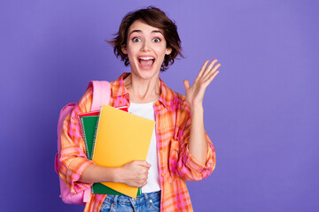 Wall Mural - Portrait of pretty young lady hold supply open mouth wear shirt isolated on purple color background