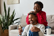 © LIGHTFIELD STUDIOS - A couple shares laughter and joy together in their warm living room during winter.