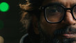 © Yuliia - Close up portrait half male serious face Indian man in eyeglasses looking at camera at parking lot underground Arabian male in glasses vision eyesight problem laser correction. Headshot homeless guy