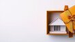 © Nattapol - real estate gift box with open house model inside represents unique gift idea for home buyers. This creative presentation symbolizes new beginnings and opportunities