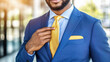 © AlgoCreative - businessman in tailored blue suit adjusting his yellow tie