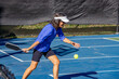 © Jo - As she drops the ball, she swings her paddle forward to strike the ball