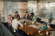 © Zamrznuti tonovi - Business team discussing strategy during meeting in modern office