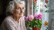 © Lion - Elderly woman looking out window, thoughtful expression, casual home interior, soft natural light, peaceful setting