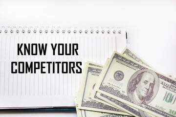 Wall Mural - know your competitors the text is written on a notepad and a white background , next to hundred doll