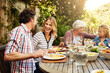 © peopleimages.com - Brunch, laughing and food with family in nature for thanksgiving event, eating and happiness. Love, support and celebration with group of people in garden of home for health, wellness and nutrition