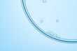 © ADDICTIVE STOCK - Close-up of bubbles in light blue transparent liquid surface
