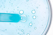 © ADDICTIVE STOCK - Blue Liquid with Bubbles in Petri Dish Captures Microscopic View