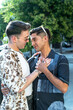 © ADDICTIVE STOCK - **Two men sharing an intimate moment on a sunny street**