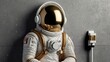 © azi - Astronaut in spacesuit sits near wall outlet.