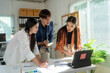© Wasana - Asian business people having meeting using laptop discussing together in office