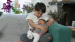 © Marco - Young boy lovingly cradling his newborn sibling on a couch, surrounded by cozy home decor, highlighting family love and bonding. Emphasizes themes of sibling affection, care, and family unity