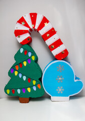 Wall Mural - Christmas piñatas with candies: Christmas tree, red Christmas candy and blue mitten with snowflakes